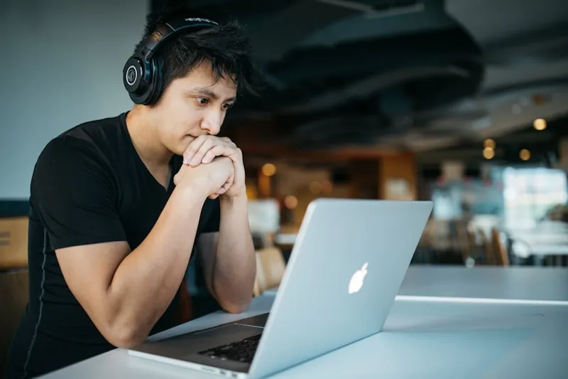 Person studying with books and notes, warm lighting representing focused reading environment